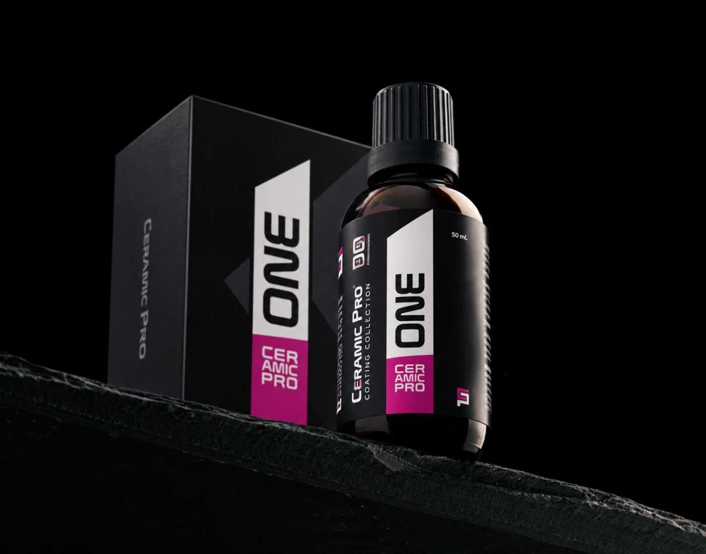 Ceramic Pro ONE ceramic coating bottle and box on a dark stone ledge