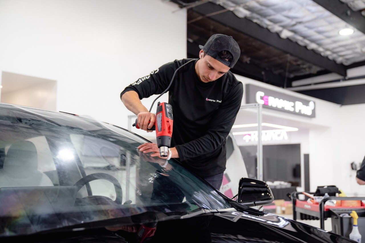 Windshield protection film being installed on a Tesla